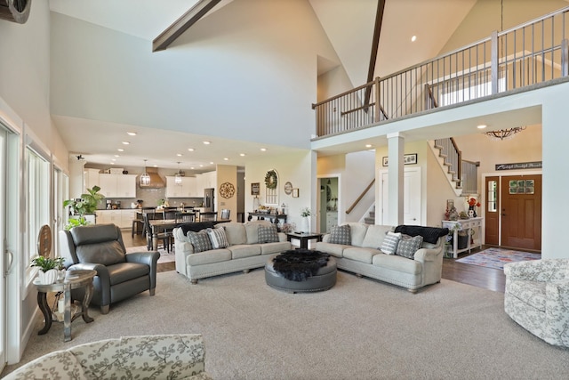 12529 E Tuscola Rd, Frankenmuth, MI 48734 - carpeted living area with high vaulted ceiling, stairs, and recessed lighting