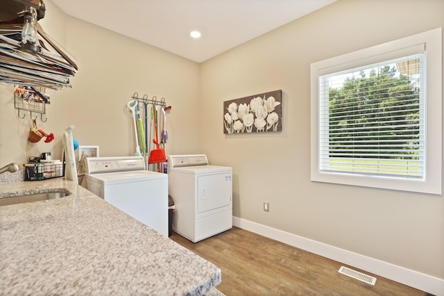 12529 E Tuscola Rd, Frankenmuth, MI 48734 - laundry room featuring washing machine and dryer, plenty of natural light, light wood finished floors, and recessed lighting