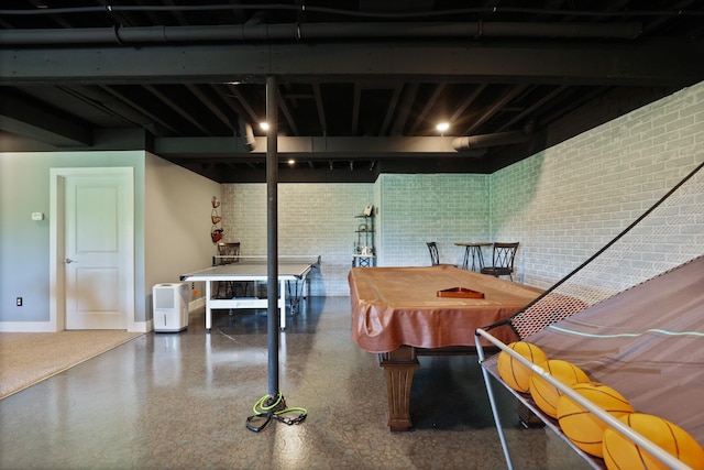 12529 E Tuscola Rd, Frankenmuth, MI 48734 - dining space featuring pool table, speckle patterned floor, and brick wall