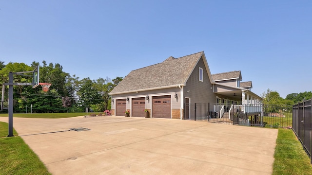 12529 E Tuscola Rd, Frankenmuth, MI 48734 - view of property exterior with driveway, brick siding, and roof with shingles