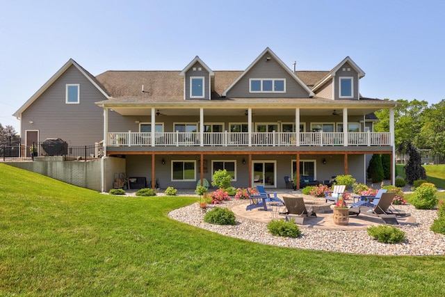 12529 E Tuscola Rd, Frankenmuth, MI 48734 - rear view of property featuring a patio area, a fire pit, a lawn, ceiling fan, and a deck