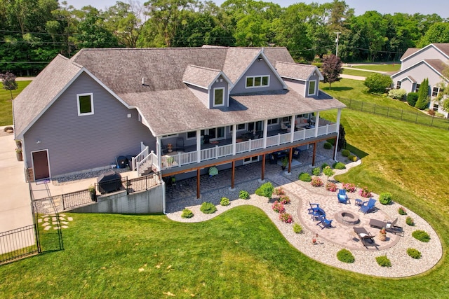 12529 E Tuscola Rd, Frankenmuth, MI 48734 - back of house with a fire pit, a patio, a fenced backyard, a shingled roof, and a deck
