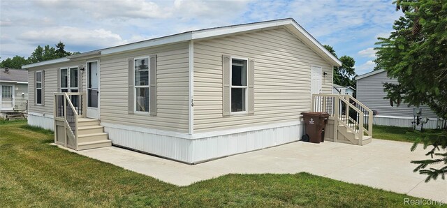 7102 Highlander Cir, Alma, MI 48801 - view of property exterior featuring a yard and a patio area