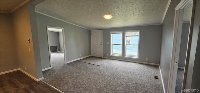 7102 Highlander Cir, Alma, MI 48801 - spare room with ornamental molding, vaulted ceiling, a textured ceiling, dark colored carpet, and dark wood-type flooring