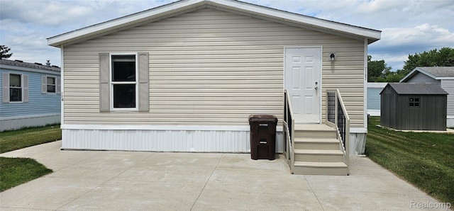 7102 Highlander Cir, Alma, MI 48801 - back of house with a shed, a patio area, and a yard