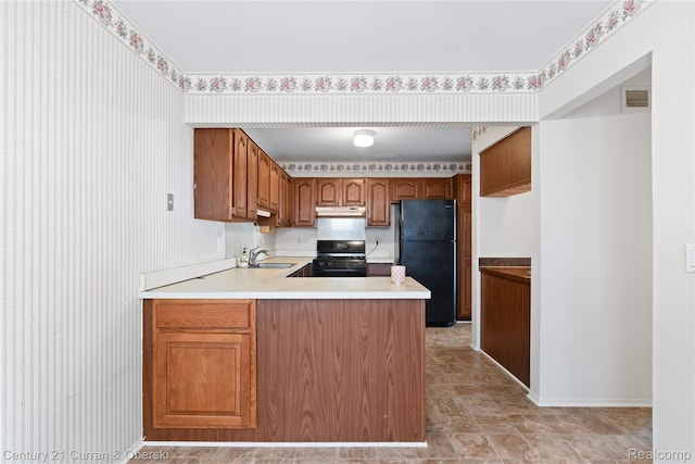 20918 W Glen Haven Cir, Novi, MI 48167 - kitchen with freestanding refrigerator, stove, a peninsula, under cabinet range hood, and stone finish flooring