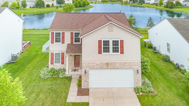 3244 Pine Run Dr, Swartz Creek, MI 48473 - view of front of home with stone siding, a garage, a water view, and roof with shingles