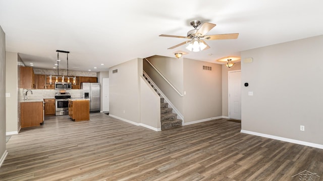 3244 Pine Run Dr, Swartz Creek, MI 48473 - kitchen featuring appliances with stainless steel finishes, open floor plan, brown cabinets, a ceiling fan, and light countertops