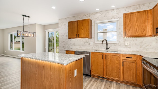 3244 Pine Run Dr, Swartz Creek, MI 48473 - kitchen featuring stainless steel appliances, a center island, light wood-style floors, light stone countertops, and recessed lighting