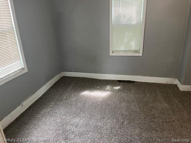 1147 Norton St, Flint, MI 48529 - spare room featuring baseboards and carpet