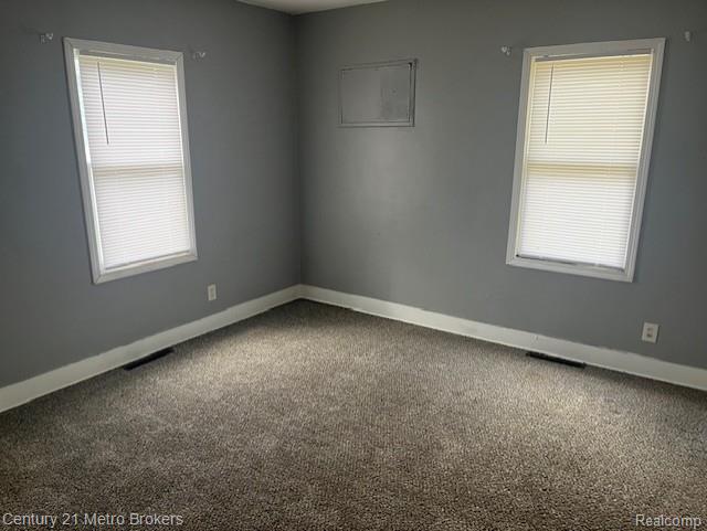 1147 Norton St, Flint, MI 48529 - empty room with carpet flooring and healthy amount of natural light