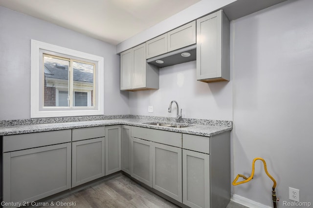20510 Rosemont Ave, Detroit, MI 48219 - kitchen featuring gray cabinets, light wood-style flooring, and light stone countertops