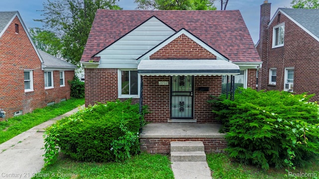 20510 Rosemont Ave, Detroit, MI 48219 - view of front of house featuring a shingled roof, brick siding, and a chimney