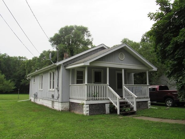 3105 N 26th St, Kalamazoo, MI 49048 - bungalow-style house featuring covered porch, a chimney, a front yard, and crawl space