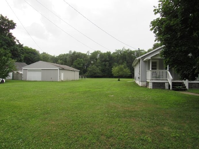 3105 N 26th St, Kalamazoo, MI 49048 - view of green lawn featuring a garage and an outbuilding