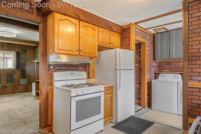 7536 Arcola St, Westland, MI 48185 - kitchen with white appliances, under cabinet range hood, washer and dryer, brick wall, and light colored carpet