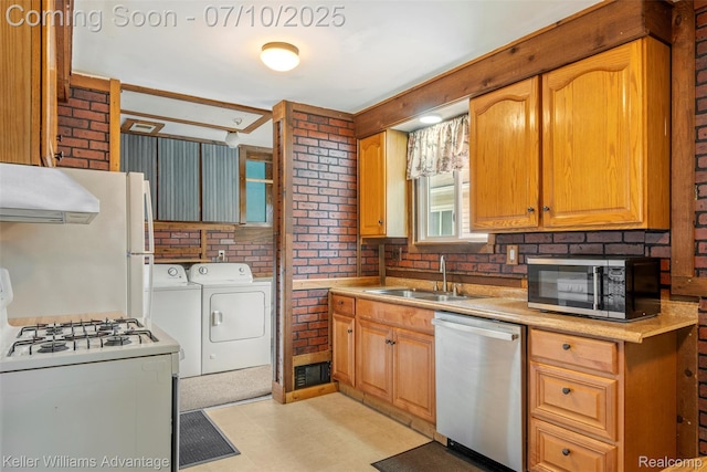 7536 Arcola St, Westland, MI 48185 - kitchen with appliances with stainless steel finishes, separate washer and dryer, ventilation hood, light flooring, and light countertops