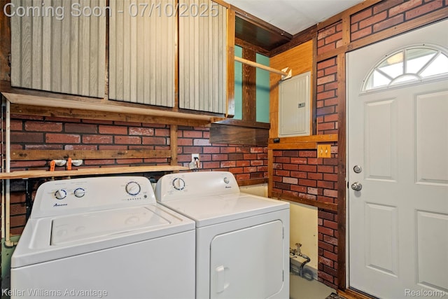 7536 Arcola St, Westland, MI 48185 - laundry room featuring electric panel, brick wall, cabinet space, and washing machine and clothes dryer