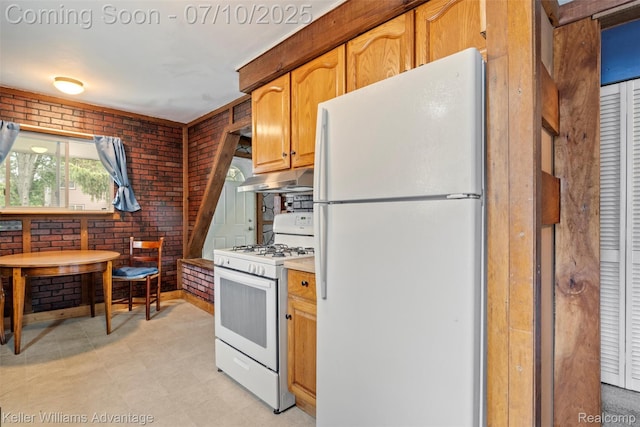 7536 Arcola St, Westland, MI 48185 - kitchen featuring white appliances, under cabinet range hood, brick wall, light countertops, and light floors