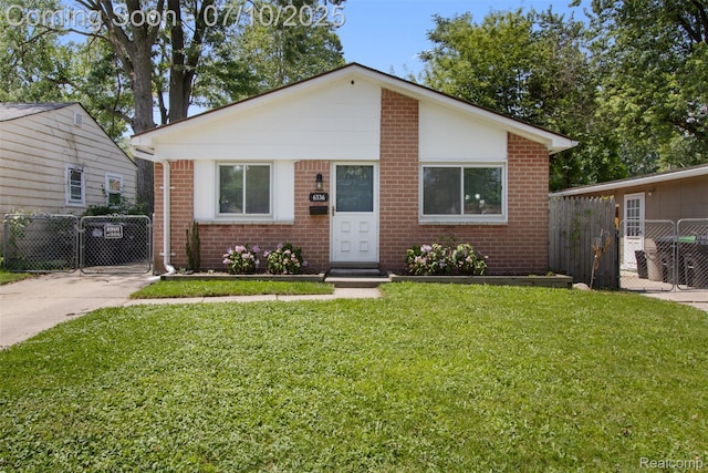 6336 Glenis St, Taylor, MI 48180 - view of front of property featuring brick siding, a gate, and concrete driveway