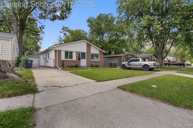 6336 Glenis St, Taylor, MI 48180 - view of front of home with brick siding, driveway, and a gate