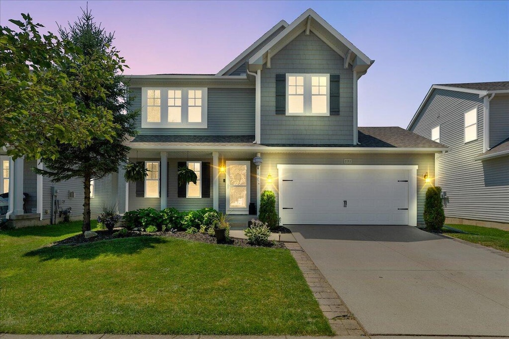 231 Merrimack Dr, Howell, MI 48843 - view of front facade featuring a front lawn, driveway, and a porch