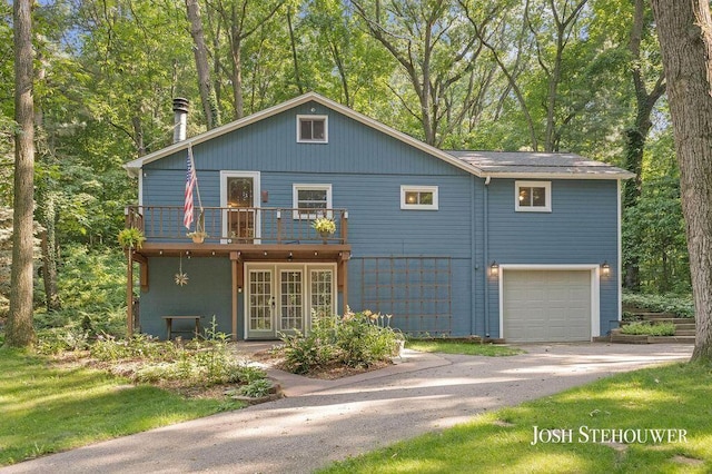 678 Pierce Rd, Plainwell, MI 49080 - view of front of home with french doors, a garage, driveway, and a deck