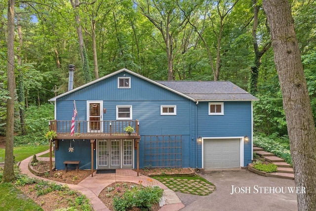 678 Pierce Rd, Plainwell, MI 49080 - view of front of home with driveway, a wooden deck, an attached garage, roof with shingles, and french doors