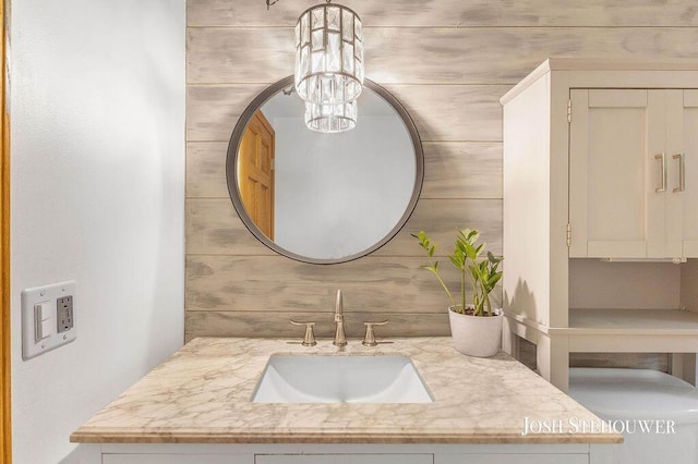 678 Pierce Rd, Plainwell, MI 49080 - bathroom with vanity and a chandelier