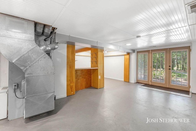 678 Pierce Rd, Plainwell, MI 49080 - unfurnished living room featuring french doors and concrete floors