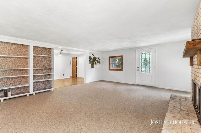 678 Pierce Rd, Plainwell, MI 49080 - unfurnished living room featuring a fireplace and carpet flooring