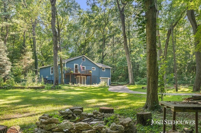 678 Pierce Rd, Plainwell, MI 49080 - view of green lawn featuring an attached garage and a wooden deck