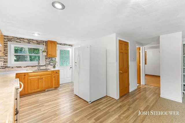 678 Pierce Rd, Plainwell, MI 49080 - kitchen featuring white fridge with ice dispenser, range, light countertops, light wood finished floors, and tasteful backsplash