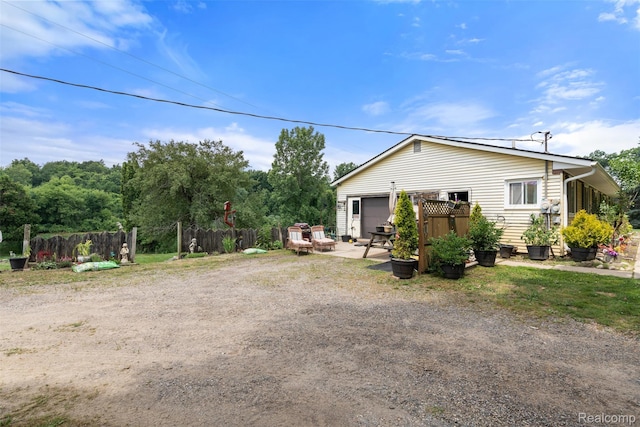 2650 N Lake George Rd, Metamora, MI 48455 - back of house featuring a garage