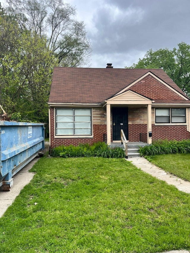 20174 San Juan Dr, Detroit, MI 48221 - view of front facade featuring brick siding and a front lawn