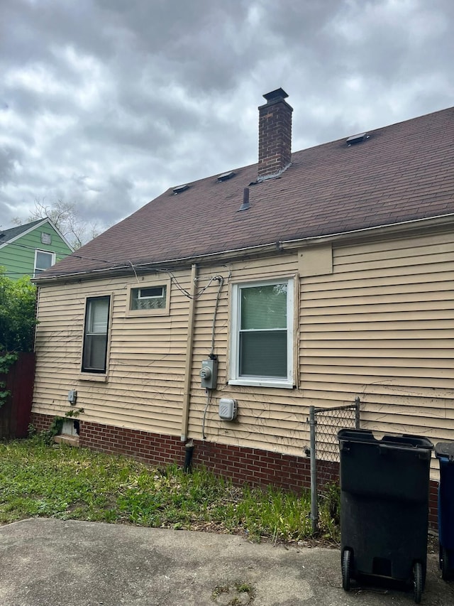 20174 San Juan Dr, Detroit, MI 48221 - view of property exterior with a chimney and roof with shingles