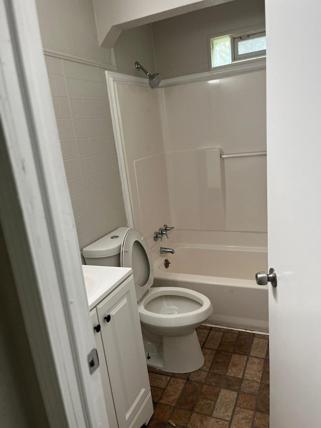 20174 San Juan Dr, Detroit, MI 48221 - bathroom featuring vanity, washtub / shower combination, brick patterned floors, and tile walls