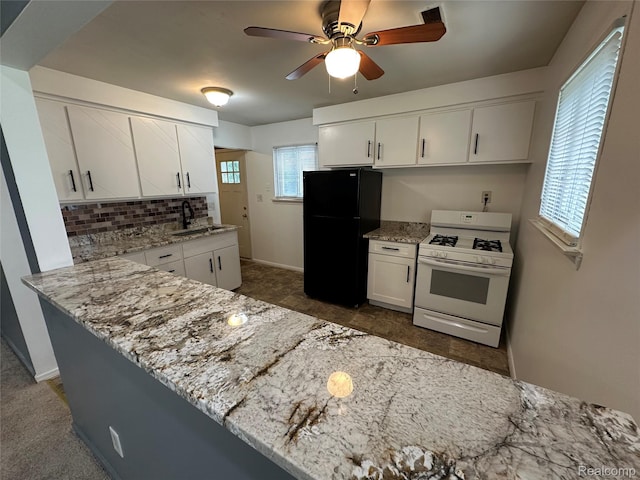 18455 Centralia, Redford, MI 48240 - kitchen with freestanding refrigerator, white range with gas cooktop, backsplash, and white cabinets