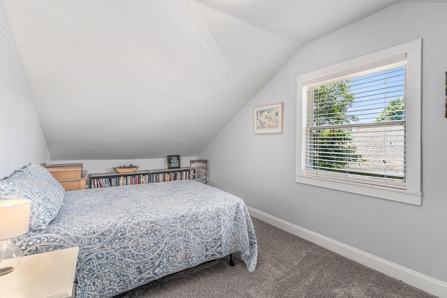 412 N Robert St, Ludington, MI 49431 - carpeted bedroom with lofted ceiling and baseboards