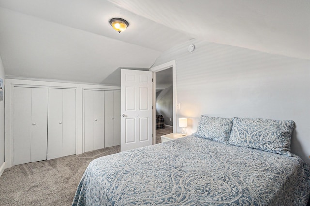 412 N Robert St, Ludington, MI 49431 - carpeted bedroom featuring vaulted ceiling and multiple closets