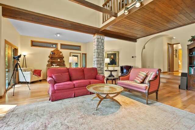 630 N 2nd St, Kalamazoo, MI 49009 - living area with light wood-style floors, arched walkways, a wooden ceiling with exposed beams, and ornate columns
