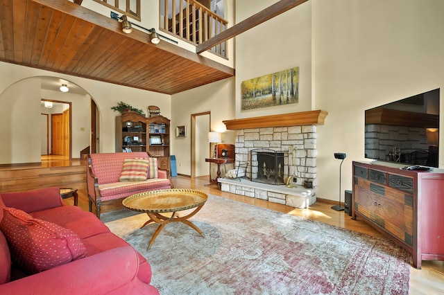 630 N 2nd St, Kalamazoo, MI 49009 - living room with a fireplace, wood finished floors, arched walkways, wooden ceiling, and a towering ceiling