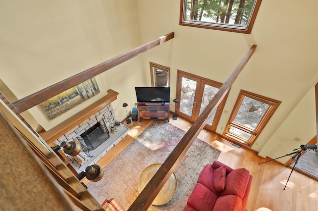 630 N 2nd St, Kalamazoo, MI 49009 - living room with a high ceiling, wood finished floors, a fireplace, and french doors