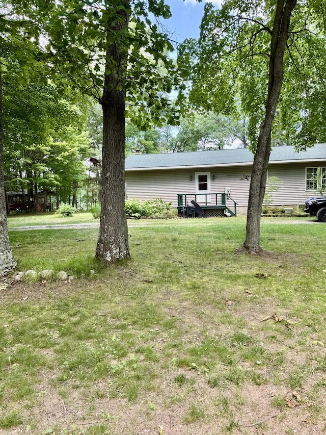 17924 Round Lake Rd, Wellston, MI 49689 - view of green lawn featuring a wooden deck