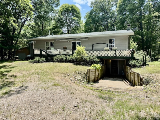 17924 Round Lake Rd, Wellston, MI 49689 - view of front of property with a chimney and a wooden deck