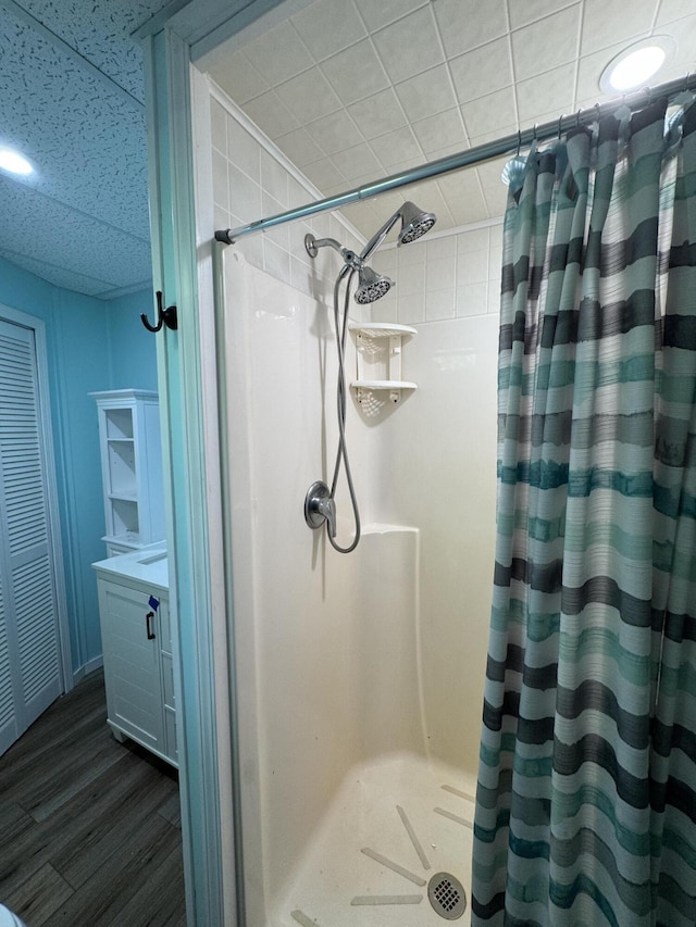17924 Round Lake Rd, Wellston, MI 49689 - bathroom with a shower stall, wood finished floors, and vanity
