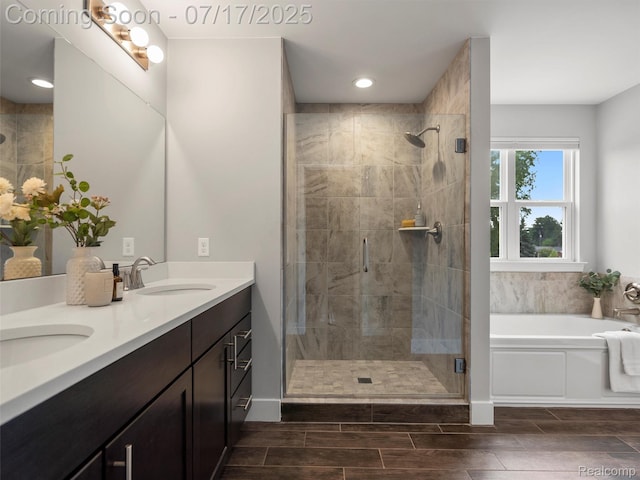 482 Wilson St, Ferndale, MI 48220 - bathroom featuring a bath, a shower stall, double vanity, recessed lighting, and wood finish floors