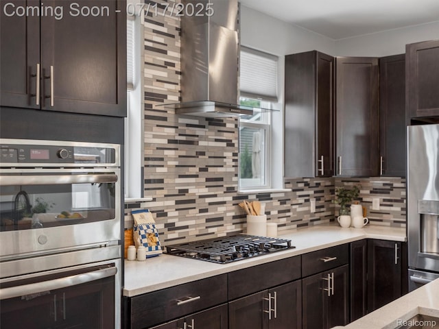 482 Wilson St, Ferndale, MI 48220 - kitchen with island range hood, appliances with stainless steel finishes, dark brown cabinets, decorative backsplash, and light countertops