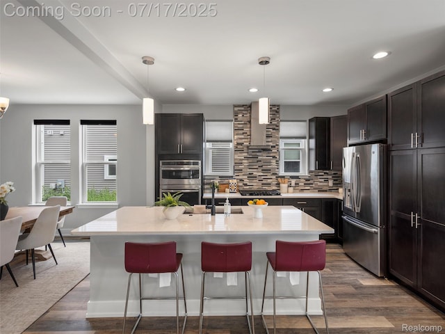 482 Wilson St, Ferndale, MI 48220 - kitchen featuring stainless steel appliances, dark wood finished floors, decorative backsplash, a breakfast bar area, and recessed lighting