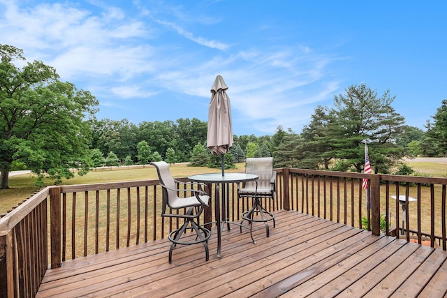 2430 140th Ave, Dorr, MI 49323 - wooden terrace with a lawn, outdoor dining area, and view of scattered trees